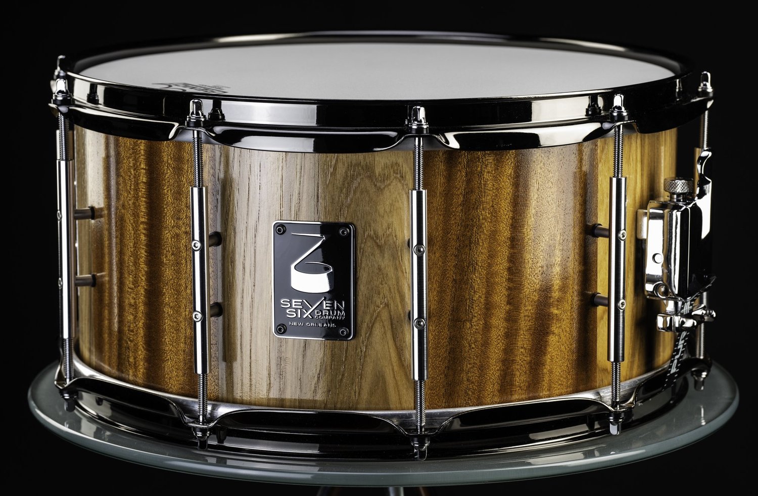 Handmade snare drum with a high-gloss natural wood shell, polished chrome tube lugs, and hoops.