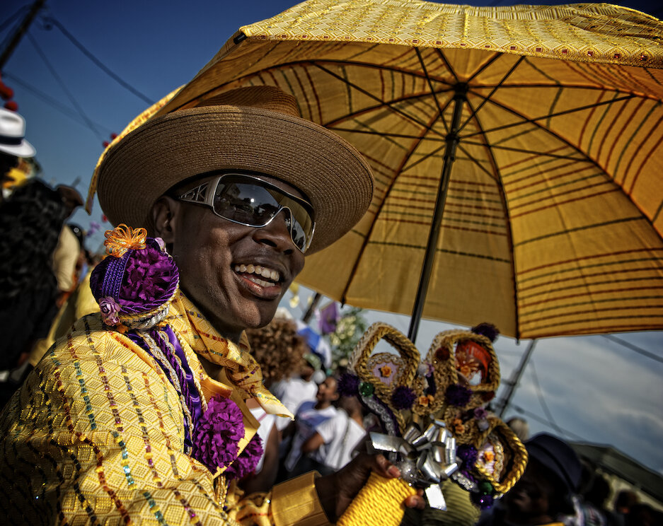 A member of the Gentlemen of Leisure Social Aid and Pleasure Club in a second line. image © Marc Pagani Photography