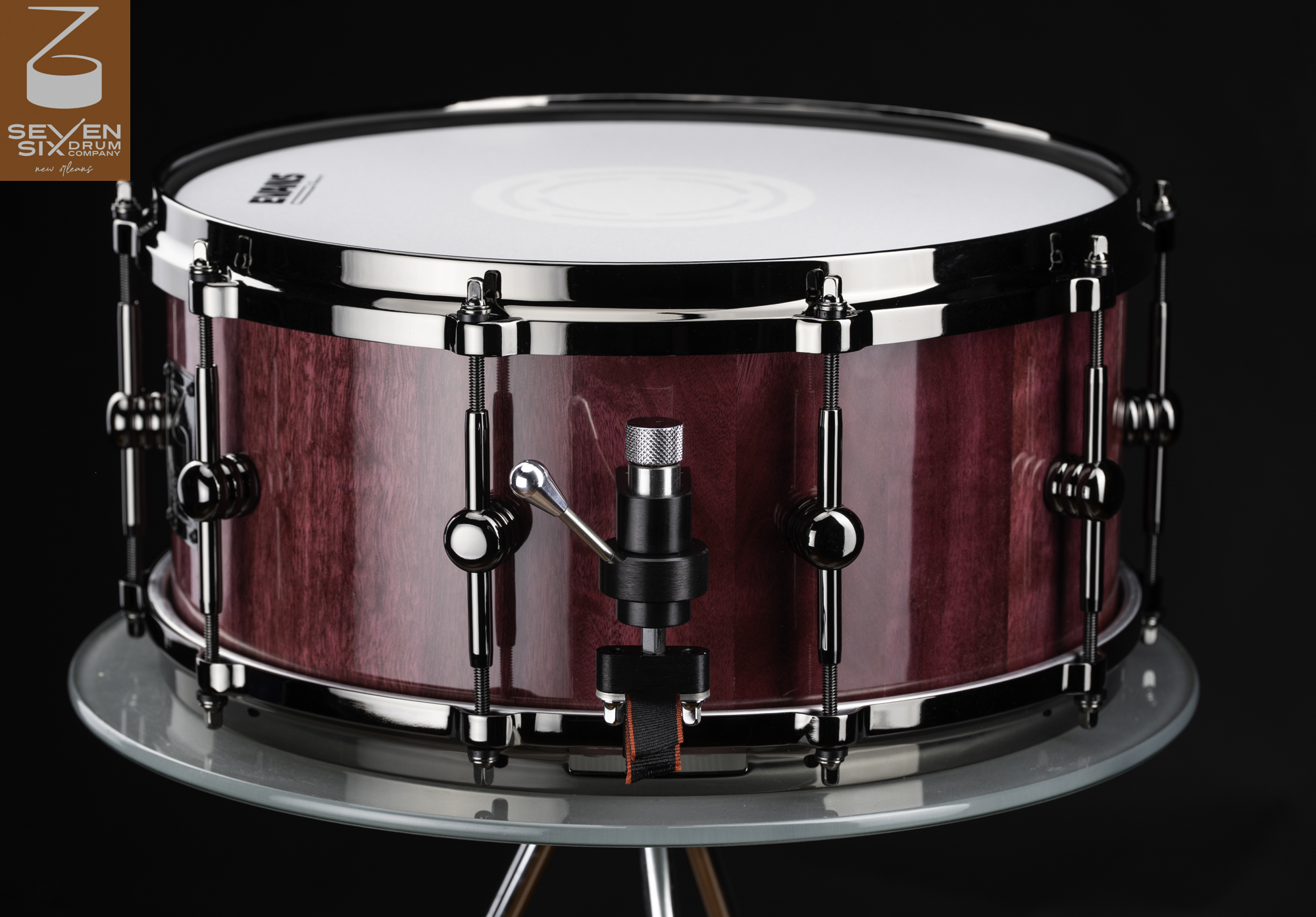 Handmade snare drum featuring a glossy purple wood shell, polished black nickel hardware, and a Trick throw-off.