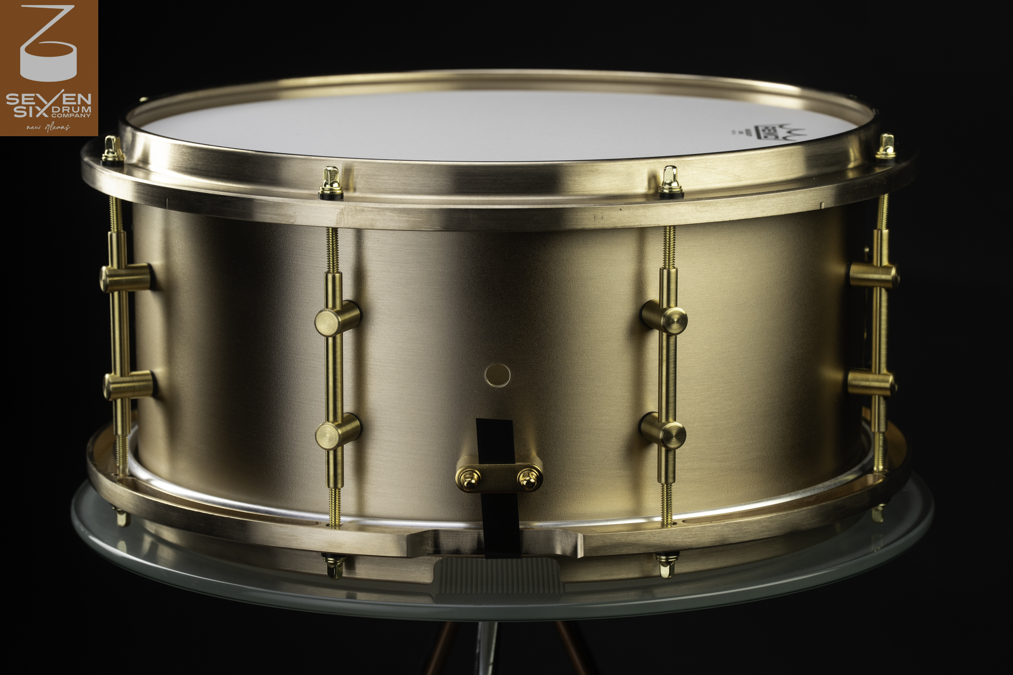 Handmade snare drum crafted in brushed brass with matching solid brass hoops and minimal tube lugs.