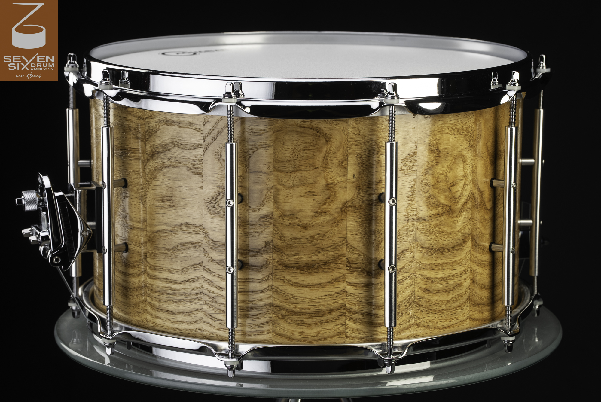 Gloss natural wood stave snare drum with polished chrome hoops, tube lugs, and throw-off.