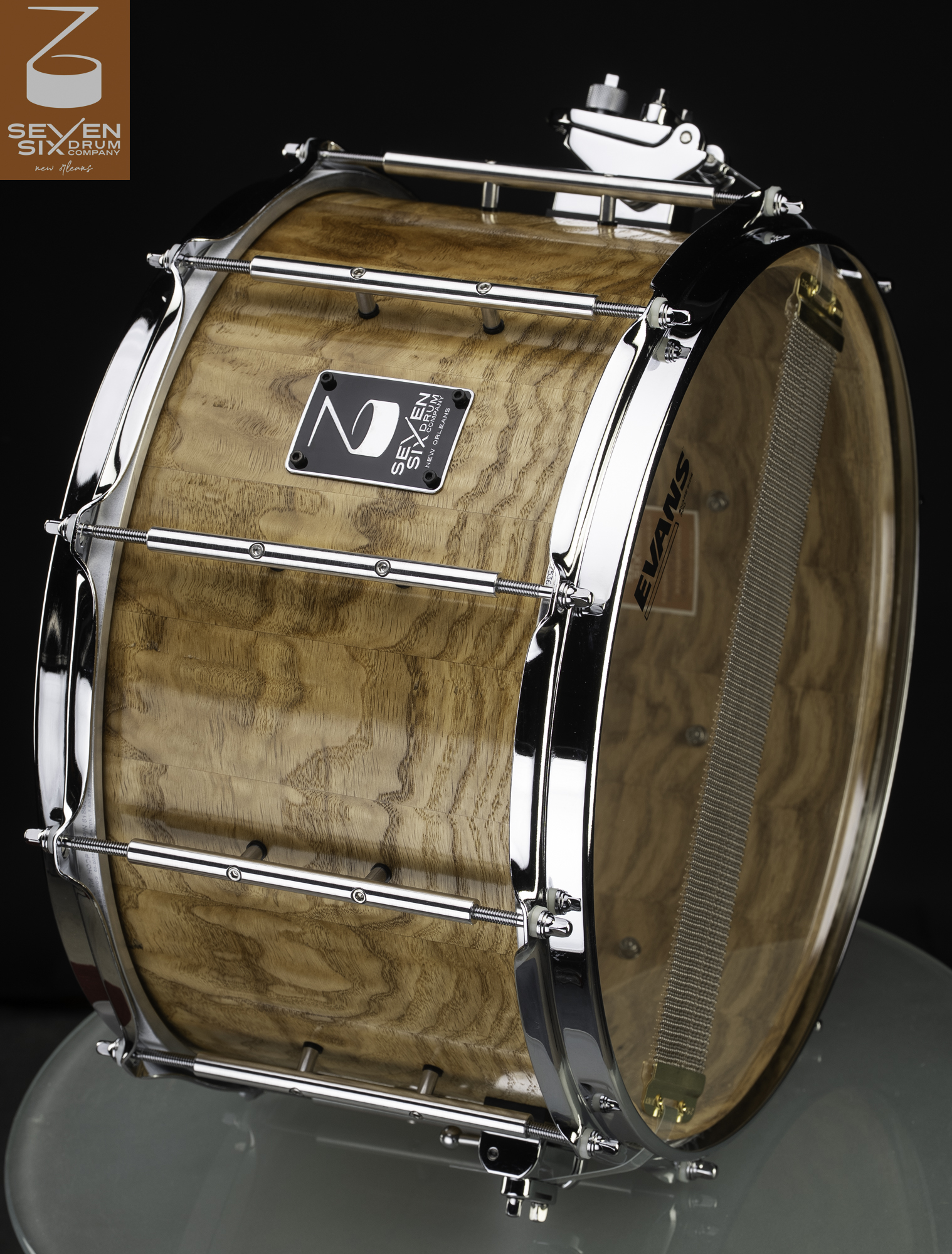 Handmade deep snare drum with a natural glossy wood shell, chrome tube lugs, and polished hoops.