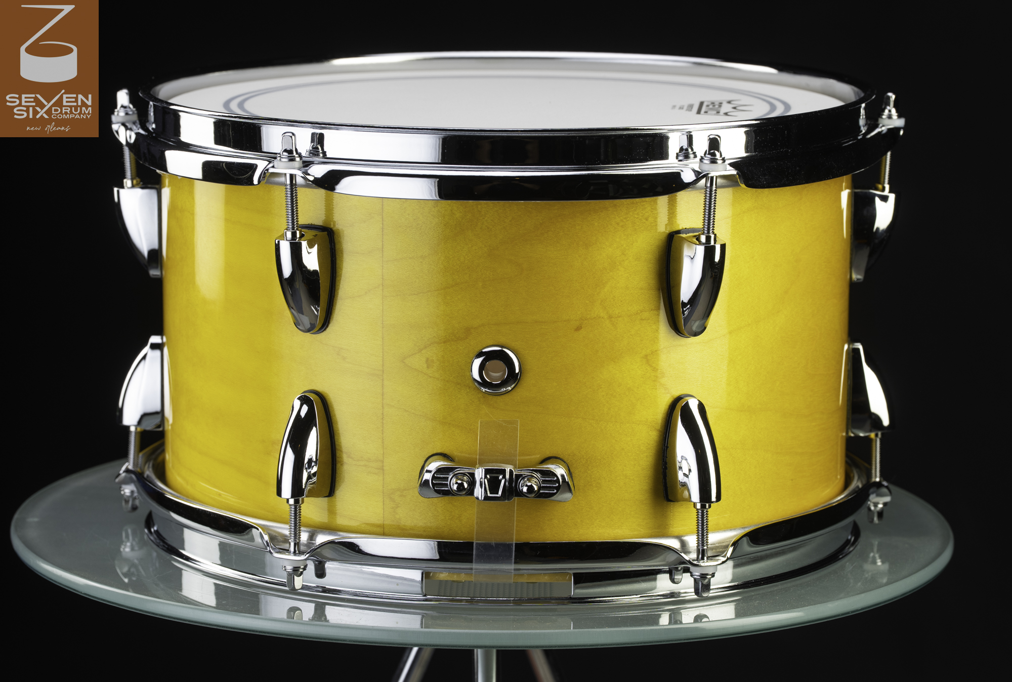 Deep wood snare drum with a glossy yellow finish and polished chrome lugs and hoops.