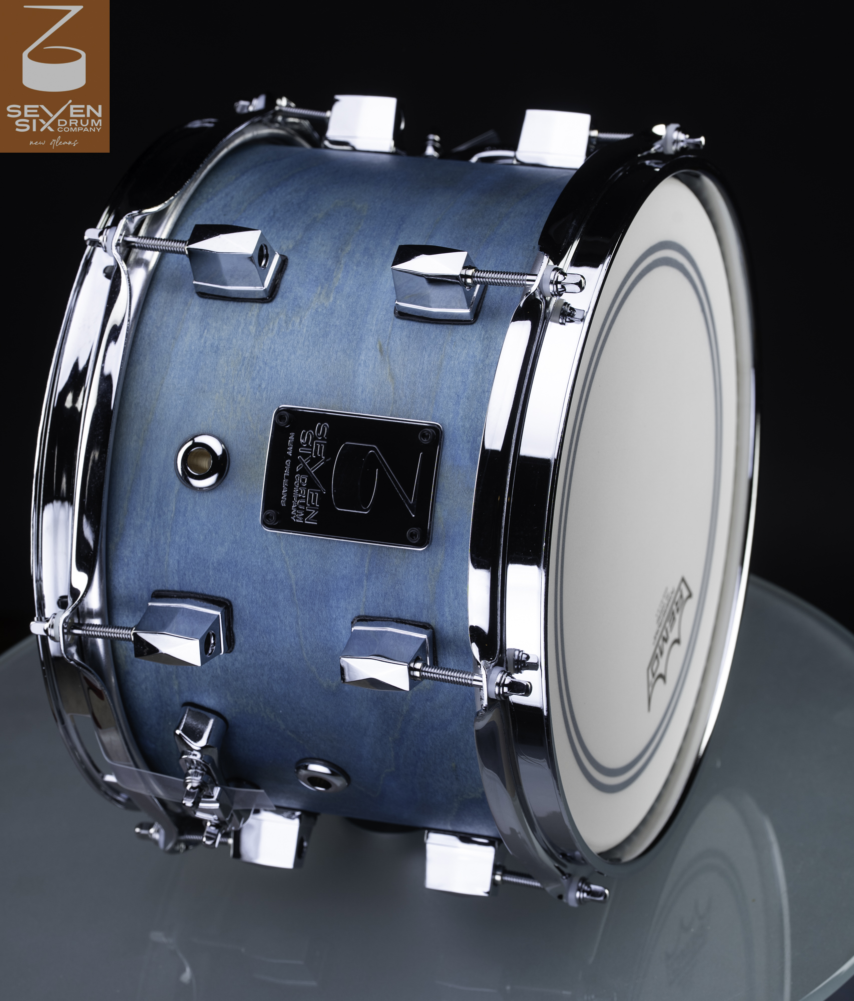 Handmade snare drum with a matte light blue stained wood shell, chrome hoops, and faceted chrome lugs.