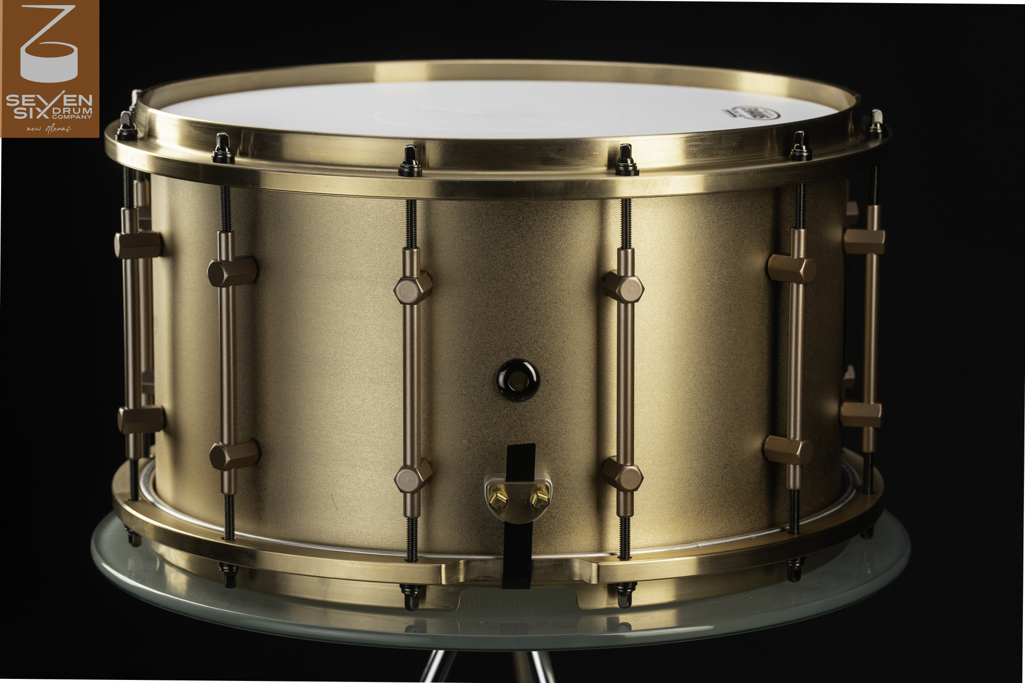 Handmade snare drum with a satin bronze shell, matching cast hoops, and bronze tube lugs.