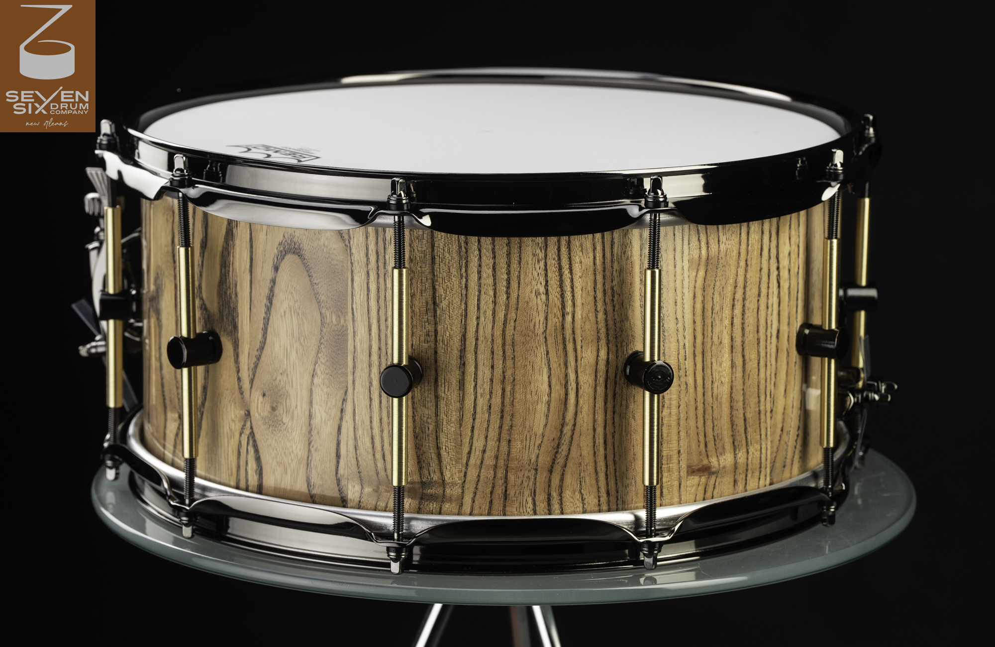 Handmade wood snare drum with a natural satin finish, brass tube lugs, and black nickel hoops.