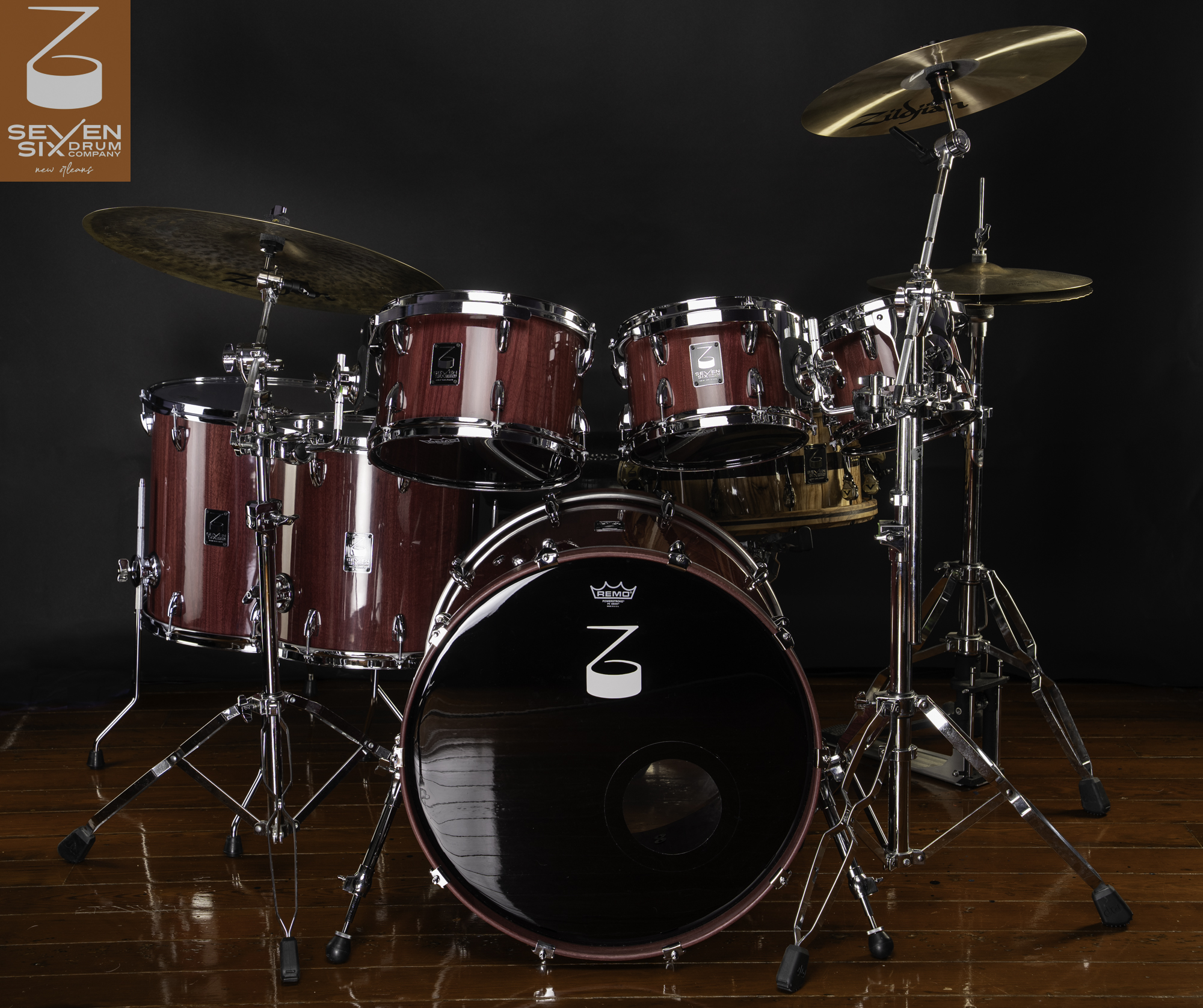 Handmade drum kit featuring glossy burgundy wood shells with polished chrome hardware and cymbals.